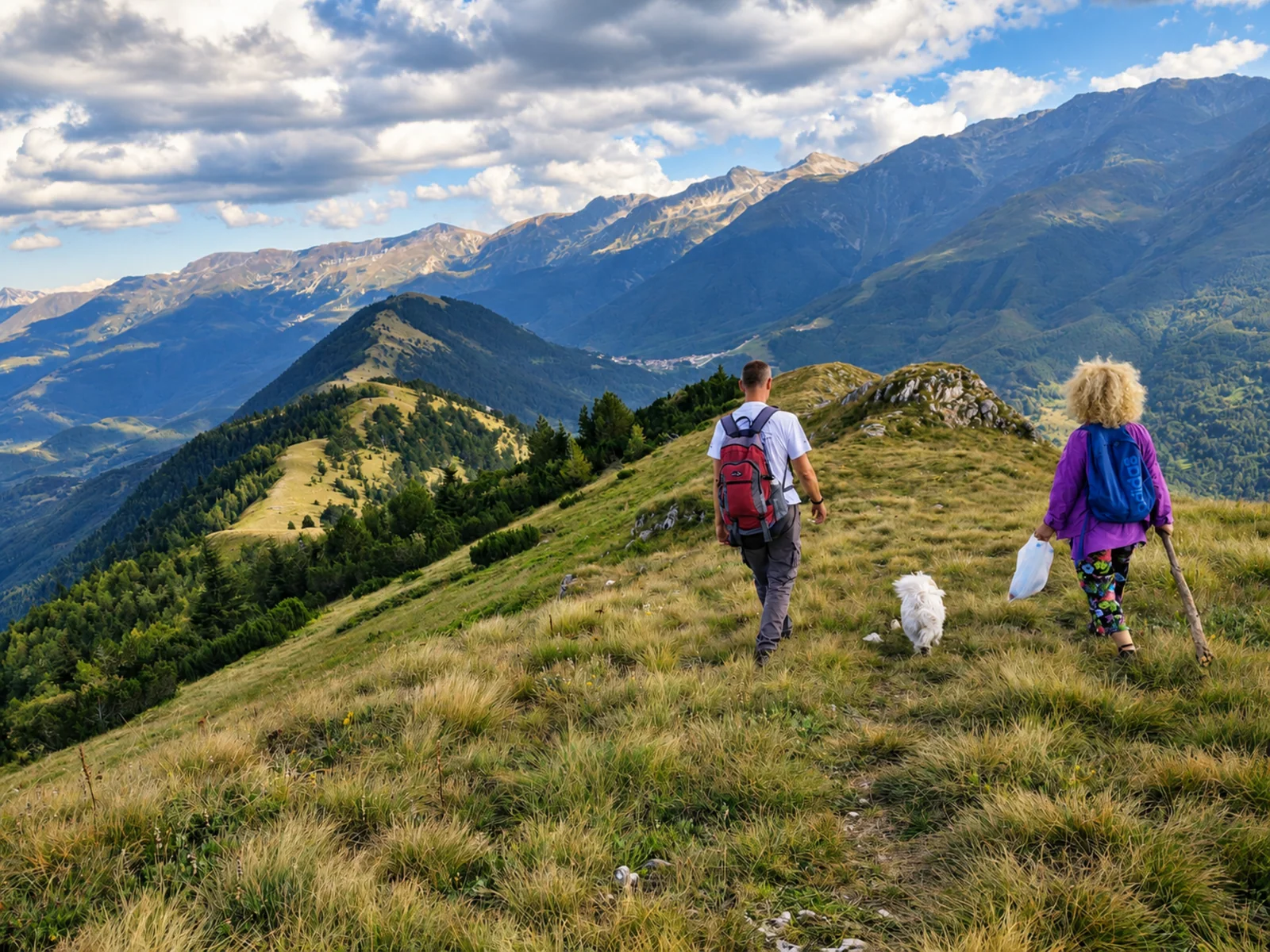 Erdis hiking on an alpine summit overlooking Kosovo mountain ranges