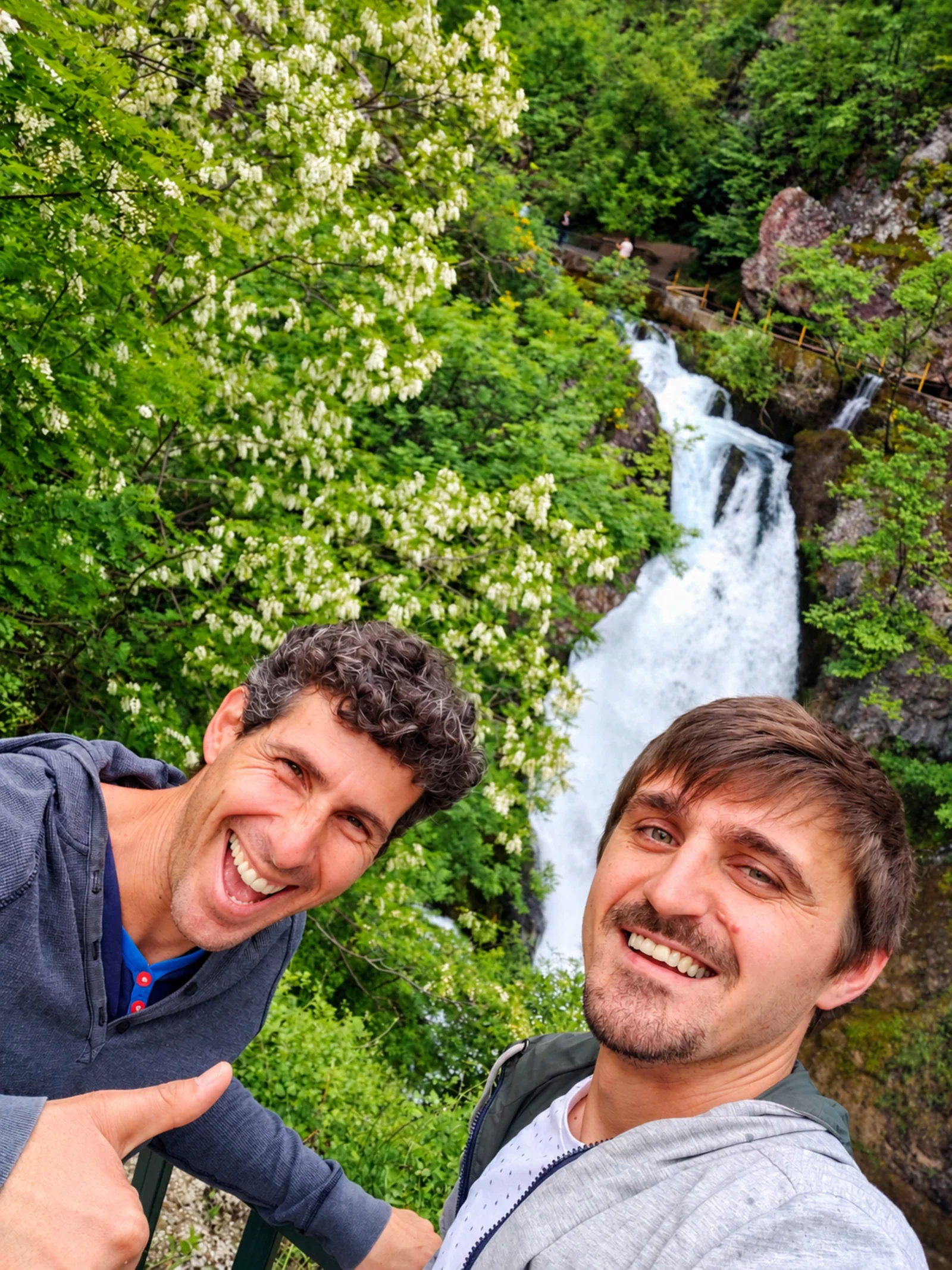 Erdis with traveler enjoying the scenic waterfalls in Kosovo