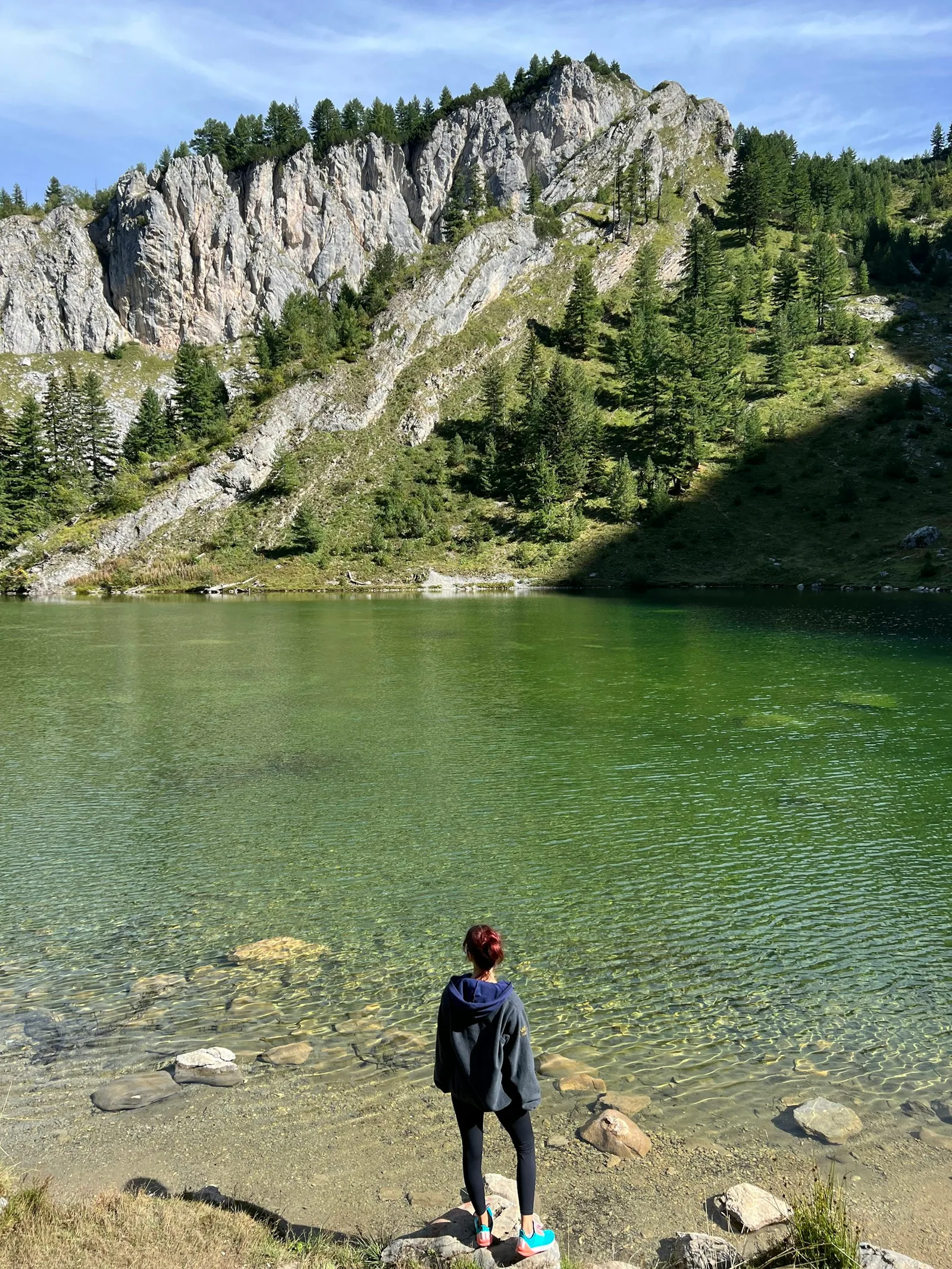 A traveller beside a mountain lake in Rugova, Kosovo